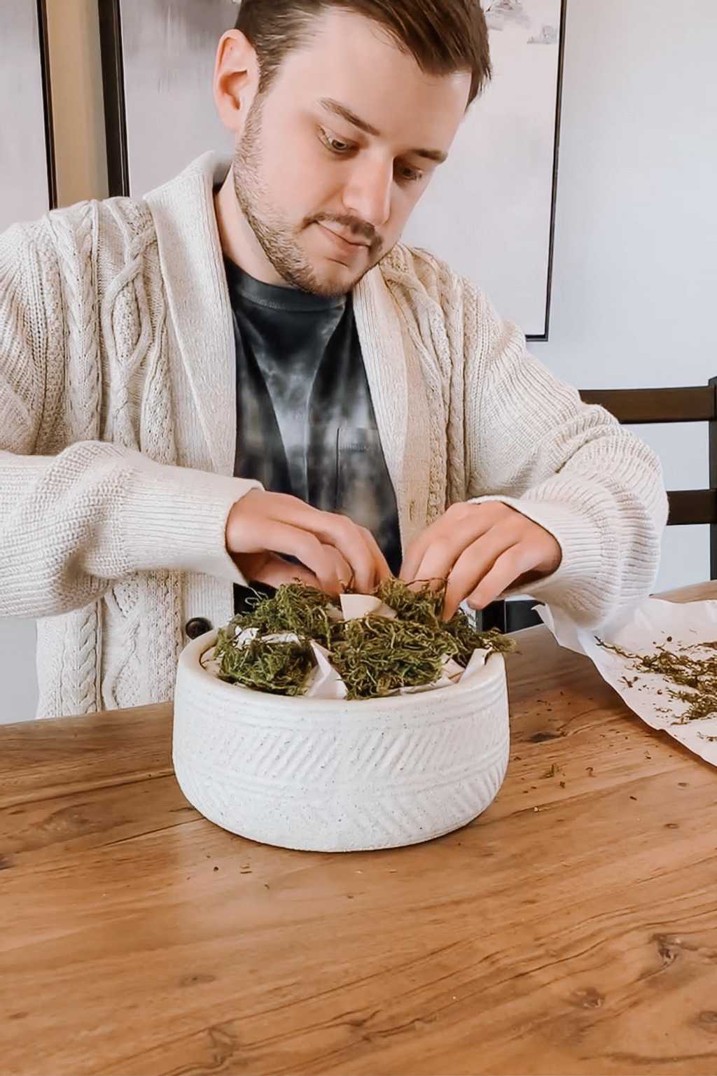 Adding Moss on top of the paper in the bowl